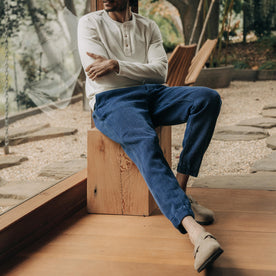 fit model sitting wearing The Apres Pant in Indigo Waffle, Bottoms by Taylor Stitch