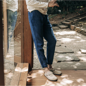 fit model leaning against the wall wearing The Apres Pant in Indigo Waffle, Bottoms by Taylor Stitch