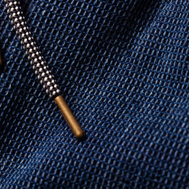 material shot of the metal tipped drawcord on The Apres Pant in Indigo Waffle, Bottoms by Taylor Stitch