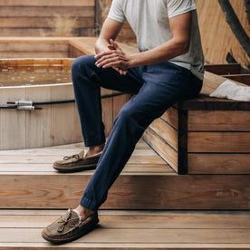 fit model sitting in The Apres Pant in Charcoal Double Cloth , Bottoms by Taylor Stitch