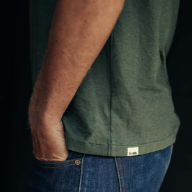 fit model showing logo and hem on The Cotton Hemp Tee in Pine, Knits by Taylor Stitch