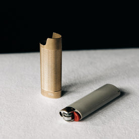 editorial image of the sleeve out of the lighter for The Lighter Sleeve in Brass, Accessories by Taylor Stitch