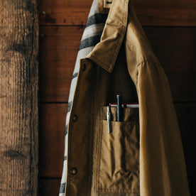 editorial image of The Lined Longshore Jacket in Harvest Tan Waxed Canvas hanging, Outerwear by Taylor Stitch