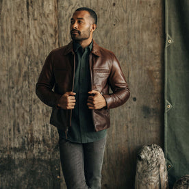 fit model sitting on a motorcycle in The Moto Jacket in Espresso Steerhide, Outerwear by Taylor Stitch