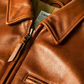 material shot of the zipper on The Moto Jacket in Whiskey Steerhide, Outerwear by Taylor Stitch