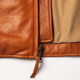 material shot of the zipper on The Moto Jacket in Whiskey Steerhide, Outerwear by Taylor Stitch