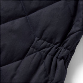 material shot of the cinched detail on The Quilted Bomber Vest in Navy Dry Wax, Outerwear by Taylor Stitch