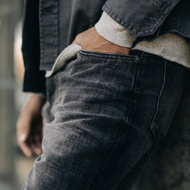 fit model with his hand in the pocket of The Slim Jean in Black 3-Month Wash Selvage, Bottoms by Taylor Stitch