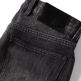 material shot of the leather logo patch on The Slim Jean in Black 3-Month Wash Selvage, Bottoms by Taylor Stitch