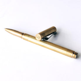 material shot of the cap and pen on The Pen in Brass, Accessories by Taylor Stitch