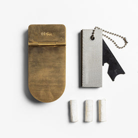 editorial image of The Tinder Box in Brass shown next to other products, Accessories by Taylor Stitch