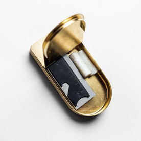 editorial image of The Tinder Box in Brass opened with products inside, Accessories by Taylor Stitch