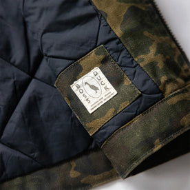 material shot of the Boss Duck logo on The Workhorse Vest in Camo Boss Duck, Outerwear by Taylor Stitch