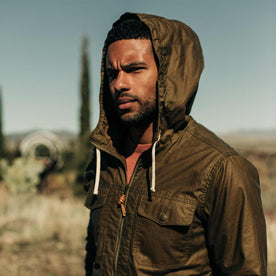 our fit model wearing The Welterweight Winslow in Field Tan Waxed Canvas out in the desert—cropped shot of chest up, Outerwear by Taylor Stitch