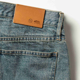 material shot of The Democratic Jean in 24-Month Wash Japanese Selvage—leather patch closeup, Denim by Taylor Stitch