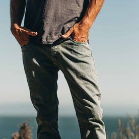 our fit model wearing The Slim Jean in 24-Month Wash Japanese Selvage—on the beach, hands in pockets, Denim by Taylor Stitch