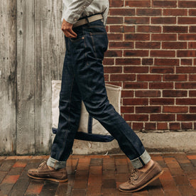 fit model wearing The Democratic Jean in Organic Selvage, walking down street, Bottoms by Taylor Stitch