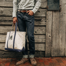 fit model wearing The Democratic Jean in Organic Selvage, cuffed, hand in pocket, Bottoms by Taylor Stitch