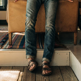 fit model wearing The Slim Jean in Organic Selvage 12-month Wash, cuffed with birks, Bottoms by Taylor Stitch