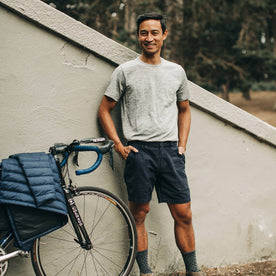 our fit model wearing The Merino Tee—in our grey colorway with his bike, Knits by Taylor Stitch