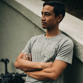 our fit model wearing The Merino Tee—in our grey shirt, arms crossed, Knits by Taylor Stitch