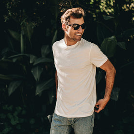 our fit model wearing The Standard Issue Tee in Natural Hemp—hand near pocket shot, Knits by Taylor Stitch