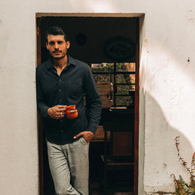 fit model wearing The California in Navy Pique, drinking coffee, Knits by Taylor Stitch