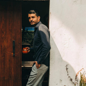 fit model wearing The California in Navy Pique, leaning against wall, Knits by Taylor Stitch