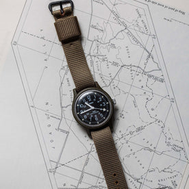 flatlay of the 1991 Timex Camper on a map, Accessories by Taylor Stitch