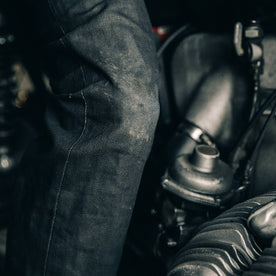 fit model wearing The Democratic Jean in Black Over-dye Selvage, knee close up, Bottoms by Taylor Stitch