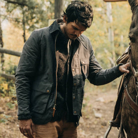 fit model wearing The Rover Jacket in Ripstop Slate Dry Wax, hand on horse, Outerwear by Taylor Stitch