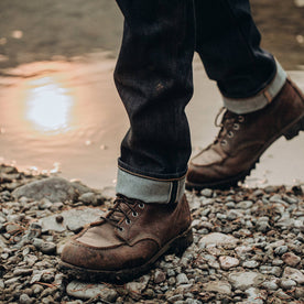 fit model wearing The Slim Jean in Cone Mills Reserve Selvage, cuffed shot over boots, Denim by Taylor Stitch