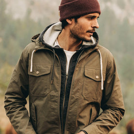 our fit model wearing The Welterweight Winslow in Olive Dry Waxed Canvas—looking right, Outerwear by Taylor Stitch