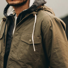 our fit model wearing The Welterweight Winslow in Olive Dry Waxed Canvas—cropped shot of chest, Outerwear by Taylor Stitch