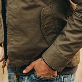 our fit model wearing The Welterweight Winslow in Olive Dry Waxed Canvas—cropped shot of pocket, Outerwear by Taylor Stitch