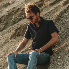 Our fit model on the beach in his Indigo Dobby short sleeve shirt, Wovens by Taylor Stitch