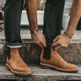 The fit model cuffing his jeans, Footwear by Taylor Stitch