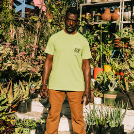 fit model wearing The Heavy Bag Tee in Chlorophyll in the garden, Knits by Taylor Stitch