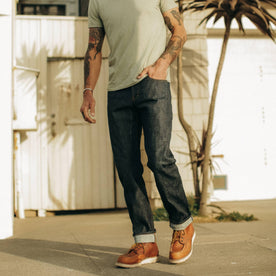 fit model walking down the street in The Democratic Jean in Natural Indigo Selvage, Bottoms by Taylor Stitch