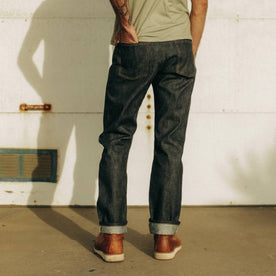 fit model wearing The Democratic Jean in Natural Indigo Selvage, shown from the back, Bottoms by Taylor Stitch