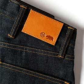 material shot of the leather patch on The Democratic Jean in Natural Indigo Selvage, Bottoms by Taylor Stitch