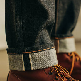 fit model wearing The Slim Jean in Natural Indigo Selvage rolled up, Bottoms by Taylor Stitch