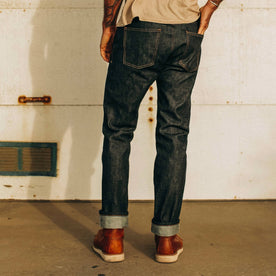 fit model wearing The Slim Jean in Natural Indigo Selvage, shown from the back, Bottoms by Taylor Stitch