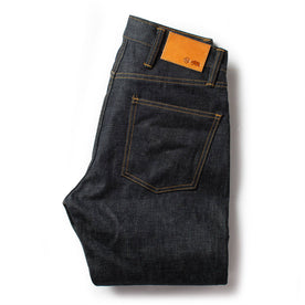 flatlay of The Slim Jean in Natural Indigo Selvage, shown folded from the back, Bottoms by Taylor Stitch