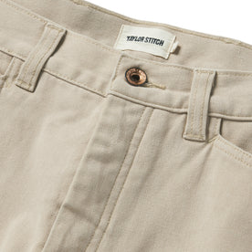 material shot of the button closure on The Shaper Short in Sand Boss Duck, Bottoms by Taylor Stitch