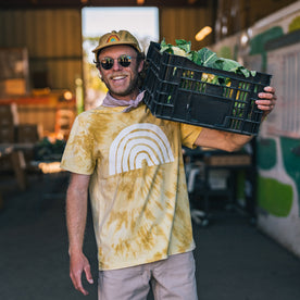 fit model balancing a basket of produce on his shoulders in The Organic Cotton Tee in Ecology Center, Knits by Taylor Stitch