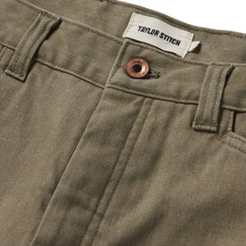 material shot of the button closure on The Shaper Short in Stone Boss Duck, Bottoms by Taylor Stitch