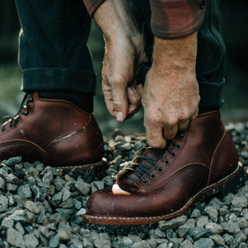 fit model tying the laces on The Backcountry Boot in Taylor Stitch Custom