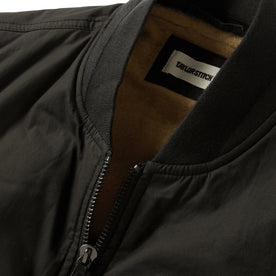 material shot of the collar and zipper on The Ignition Vest in Coal Dry Wax, Outerwear by Taylor Stitch