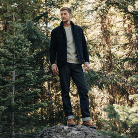 fit model standing on a rock in The Slim Jean in Cone Mills Cordura Denim, Bottoms by Taylor Stitch